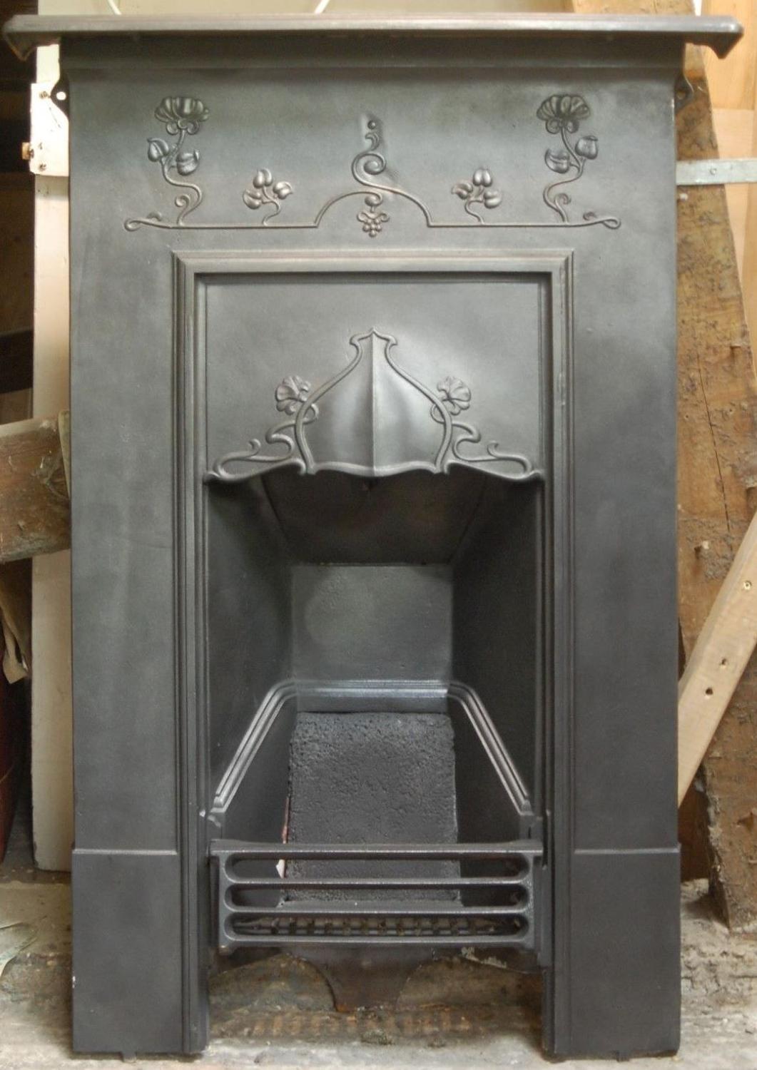An attractive Art Nouveau cast iron combination bedroom fire
