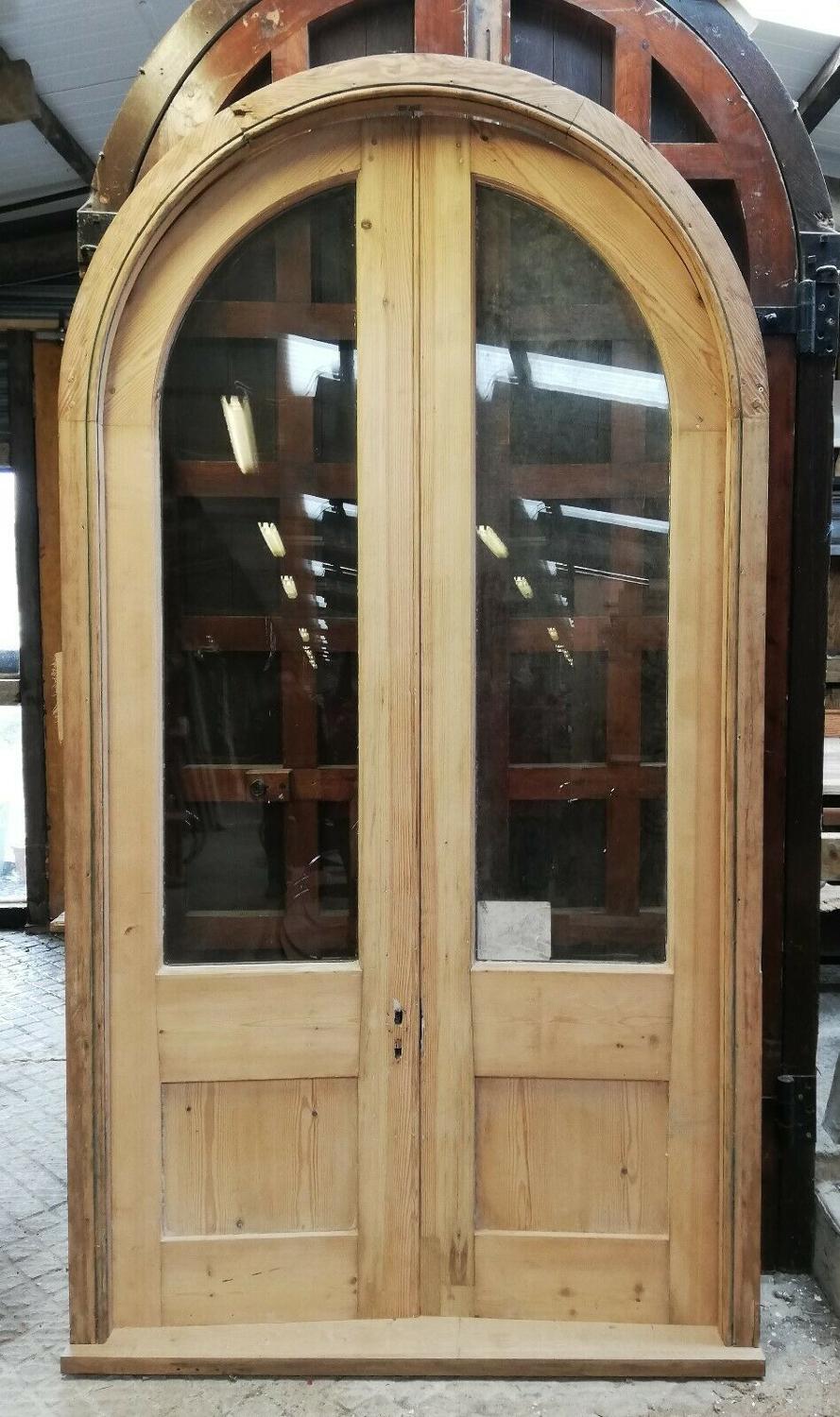 DP0274 PAIR OF SUBSTANTIAL ARCHED GLAZED PINE DOORS AND FRAME