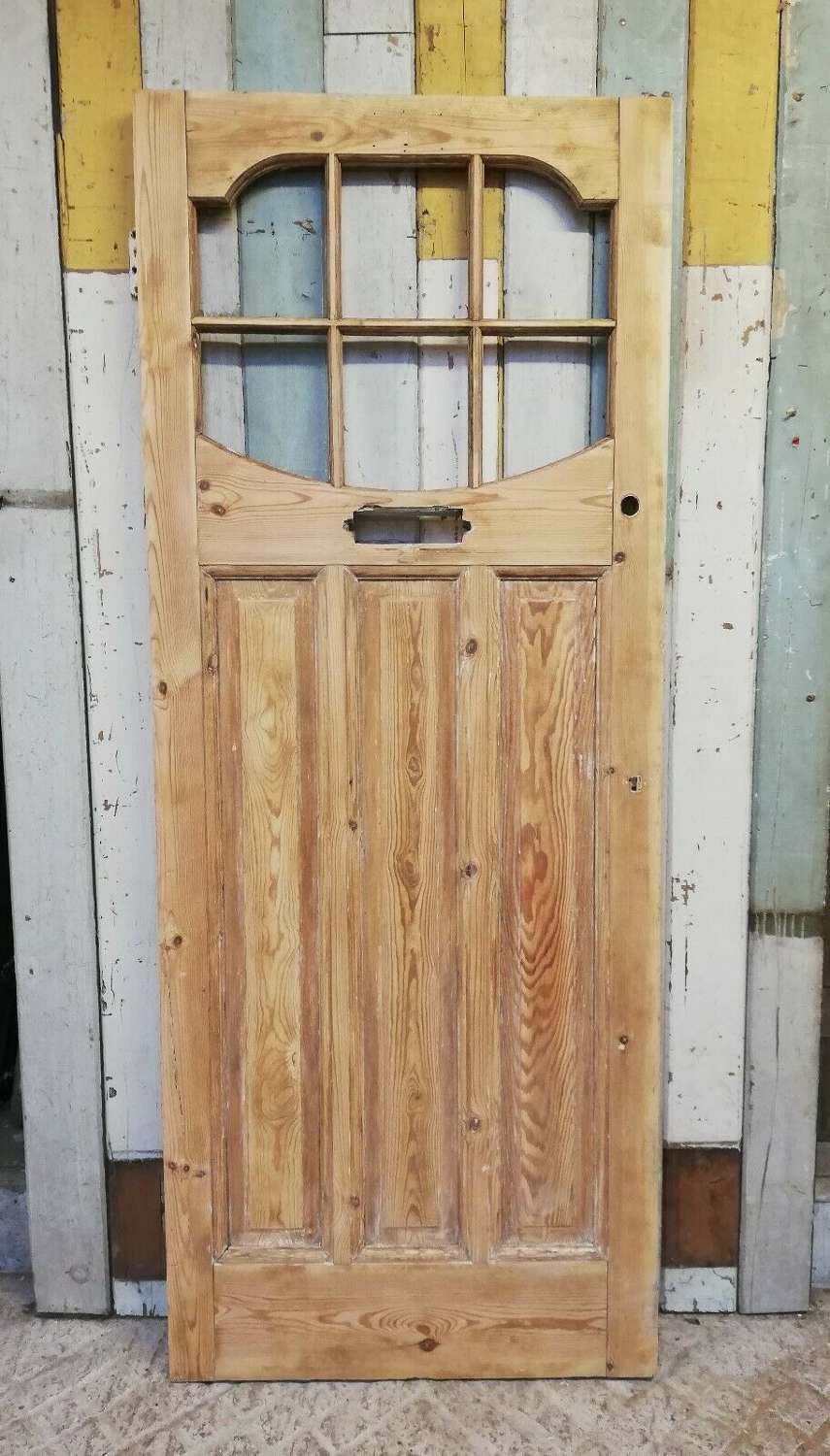 DE0525 A STRIPPED PINE EDWARDIAN FRONT DOOR WITH PANELS FOR GLAZING