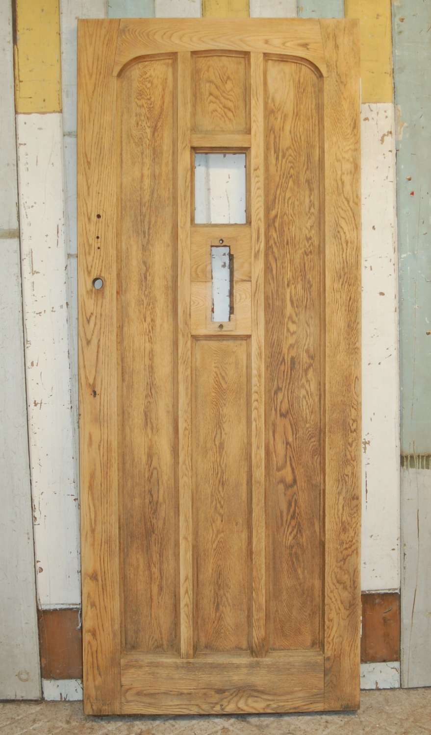 DE0824 A RECLAIMED BARE OAK FRONT DOOR WITH PANEL FOR GLAZING
