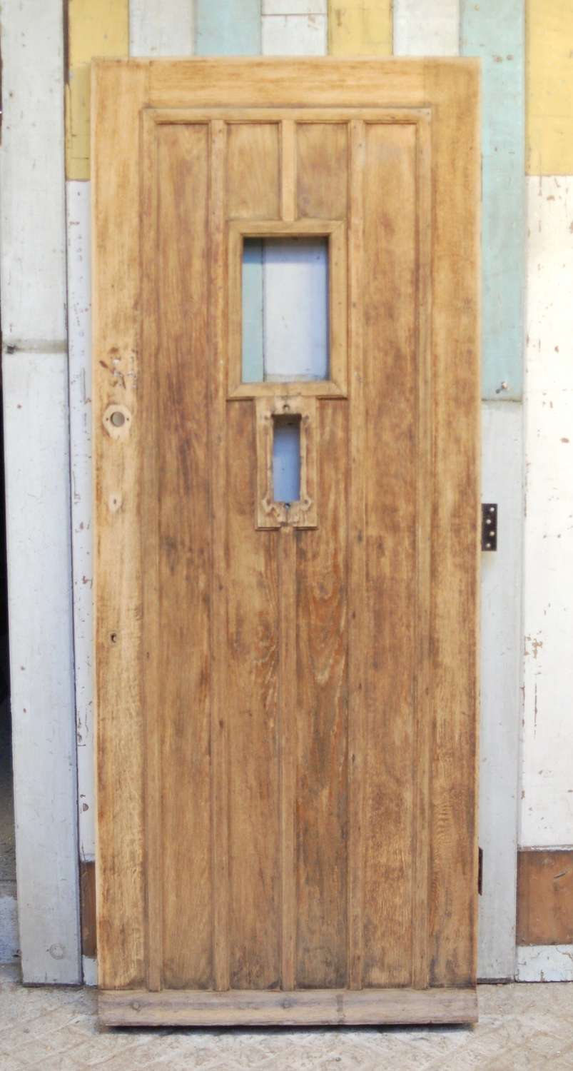 DE0825 A RECLAIMED BARE OAK FRONT DOOR WITH PANEL FOR GLAZING