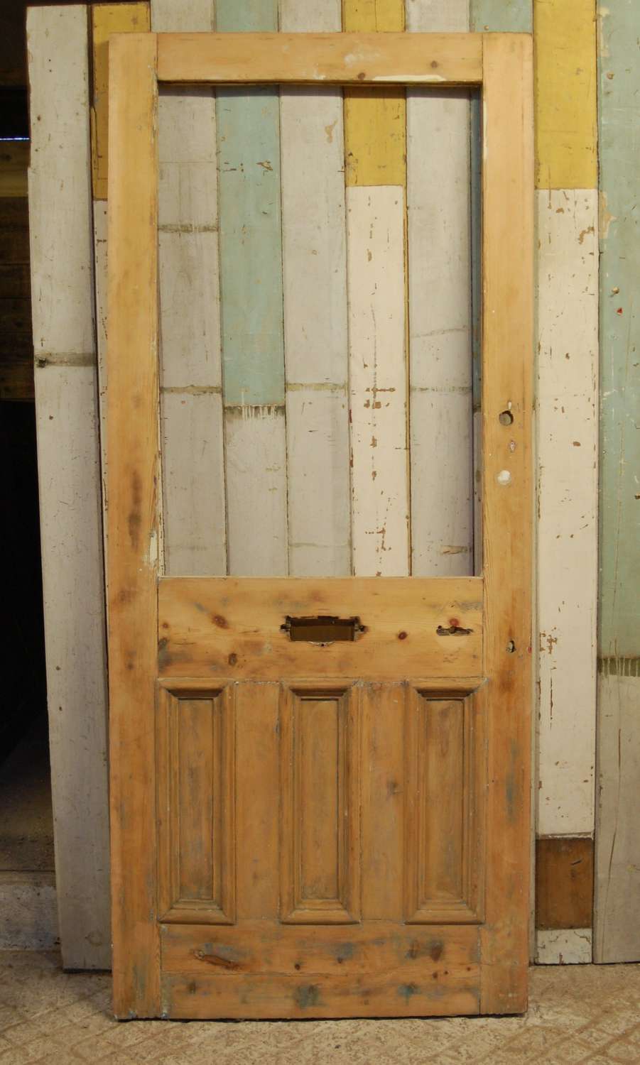DE0826 A RECLAIMED STRIPPED PINE FRONT DOOR WITH PANEL FOR GLAZING