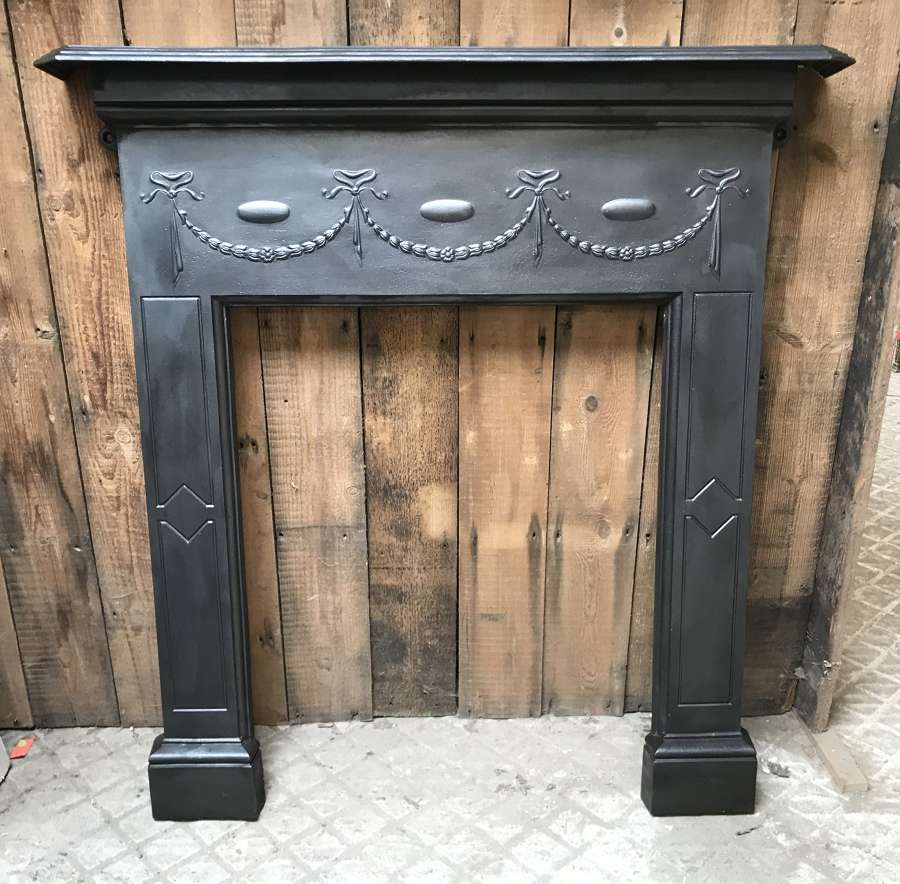 FS0112 A RECLAIMED EDWARDIAN CAST IRON FIRE SURROUND FOR WOOD BURNER