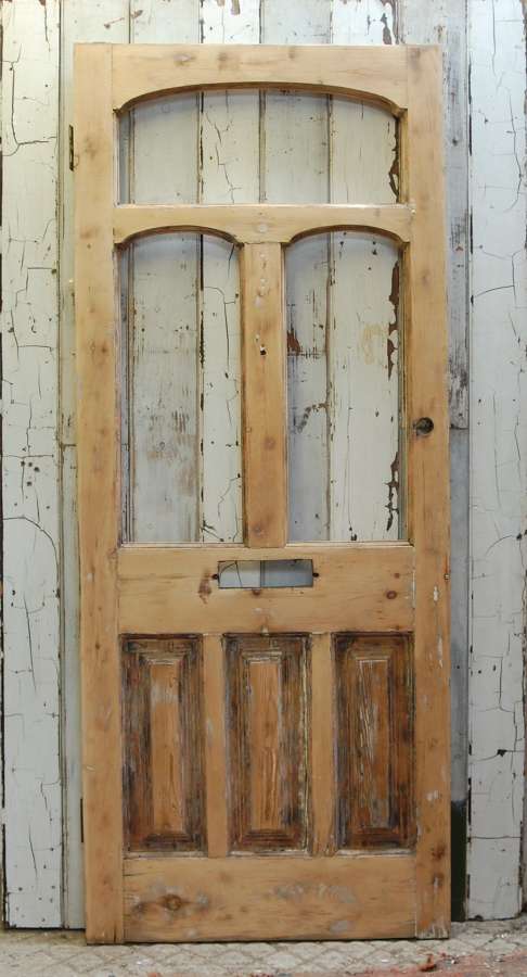 DE0849 A STRIPPED PINE VICTORIAN FRONT DOOR WITH PANELS FOR GLAZING
