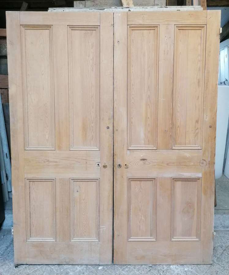 DP0389 A PAIR OF RECLAIMED VICTORIAN 4 PANEL STRIPPED PINE DOORS