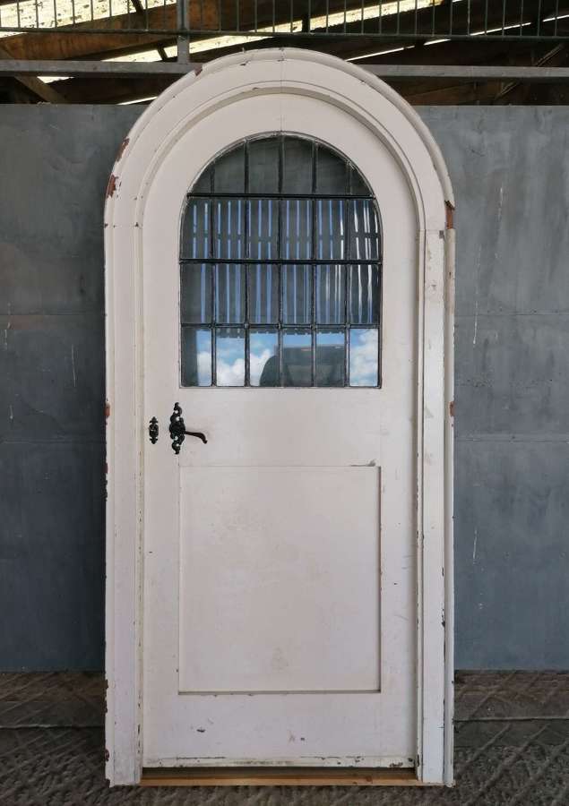 DI0785 A RECLAIMED PITCH PINE GLAZED INTERNAL ARCHED DOOR AND FRAME