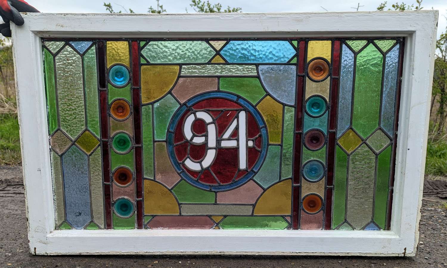 M1858 A RECLAIMED STAINED GLASS WINDOW WITH 10 PRETTY ROUNDELS