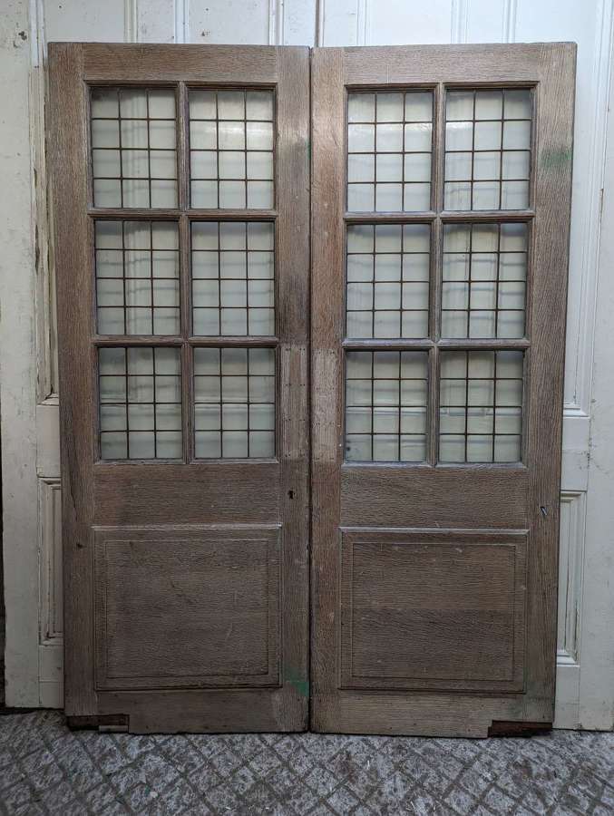 DP0496 A PAIR OF RECLAIMED GLAZED BRONZE CASEMENT OAK DOORS C.1910
