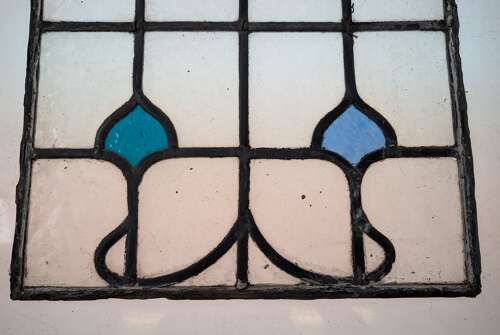 M2312 A SET OF FOUR LARGE RECLAIMED STAINED GLASS PANELS C.1920s
