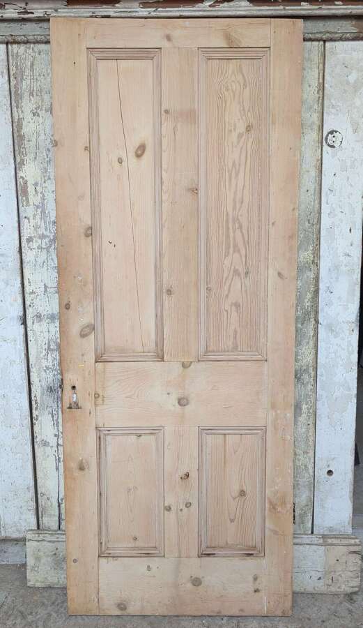 DI1123 A RECLAIMED STRIPPED PINE FOUR PANEL INTERNAL DOOR