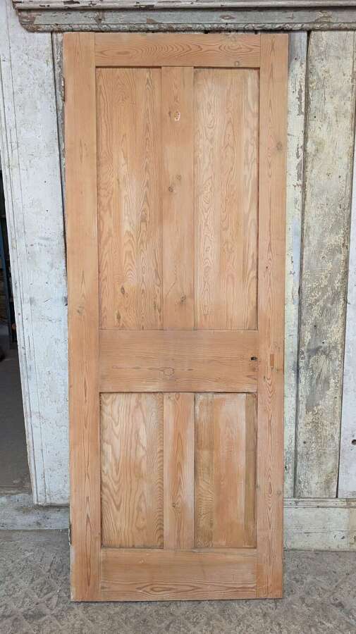 DI1125 A RECLAIMED STRIPPED PINE FOUR PANEL INTERNAL DOOR